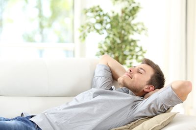 Man-on-sofa-breathing-fresh-indoor-air