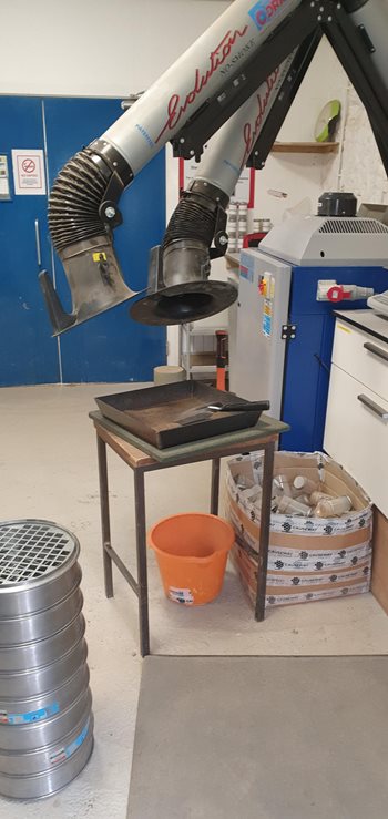 Dust extraction arms at laboratory workstation